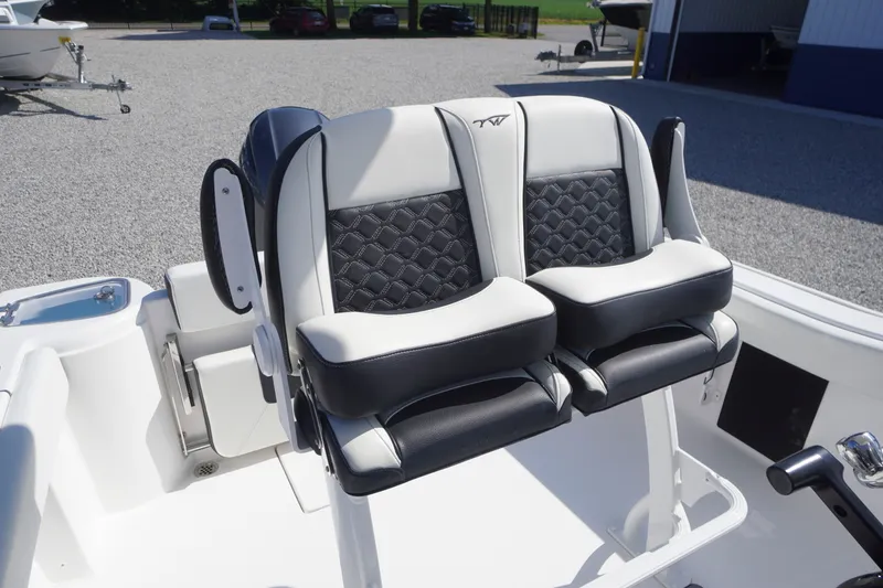 Slide: The Image of 2023 Tidewater 220 CC Adventure boat seats with black and white upholstery. - 18