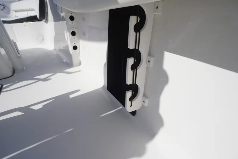 Slide: The Image of 2023 Tidewater 220 CC Adventure boat interior with rod holders and storage compartment. - 37