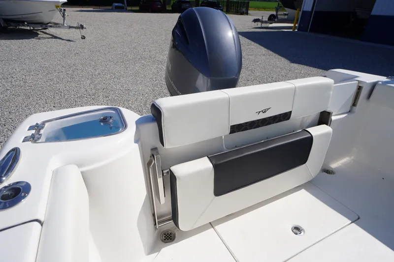 Slide: The Image of 2023 Tidewater 220 CC Adventure boat interior with sleek seating and motor detail. - 40