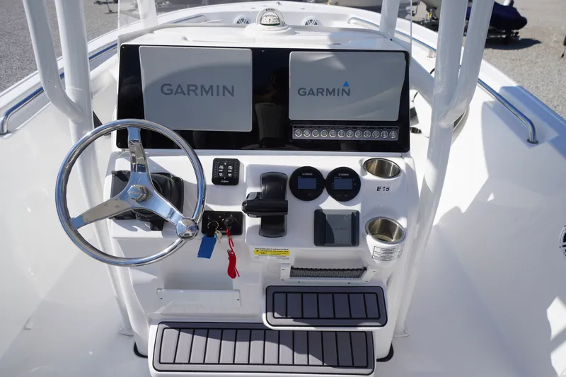 Slide: The Image of 2023 Tidewater 220 CC Adventure boat console with Garmin displays and steering wheel. - 20
