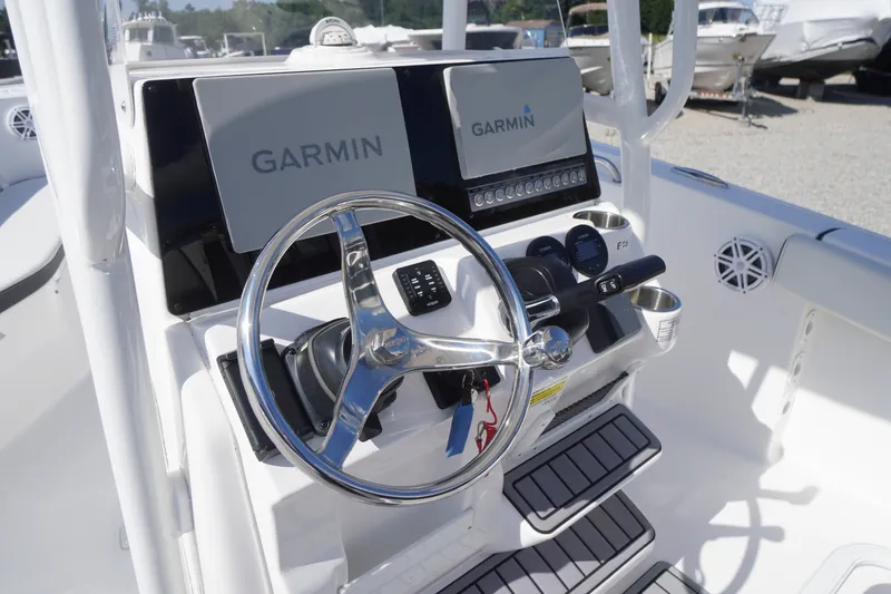 Slide: The Image of 2023 Tidewater 220 CC Adventure boat dashboard with Garmin displays and steering wheel. - 21
