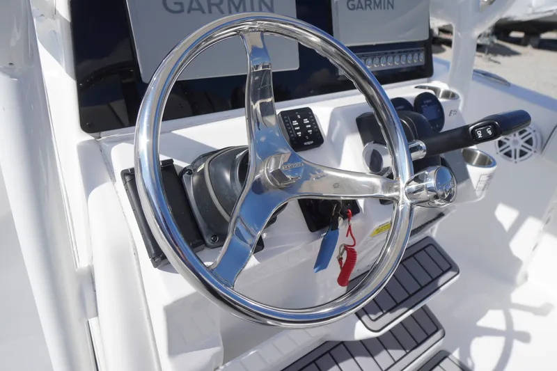 Slide: The Image of Steering wheel of 2023 Tidewater 220 CC Adventure boat with Garmin navigation system. - 22