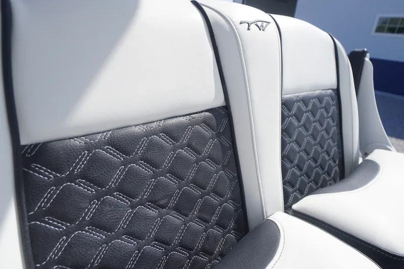 Slide: The Image of 2023 Tidewater 220 CC Adventure boat seats with elegant black and white stitching. - 19