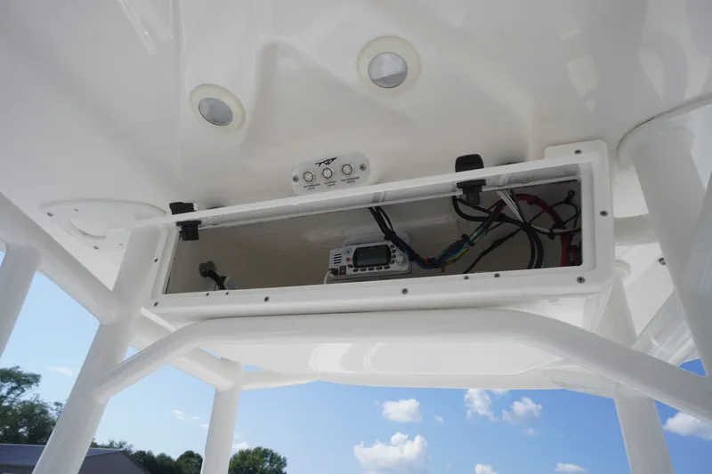 Slide: The Image of 2023 Tidewater 220 CC Adventure boat console with open electronics compartment. - 32