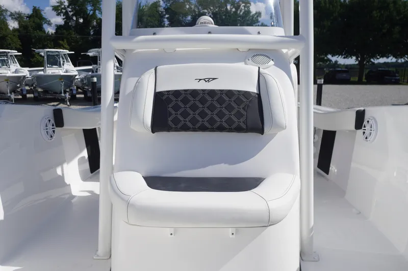 Slide: The Image of 2023 Tidewater 220 CC Adventure boat interior with cushioned seating and sleek design. - 14