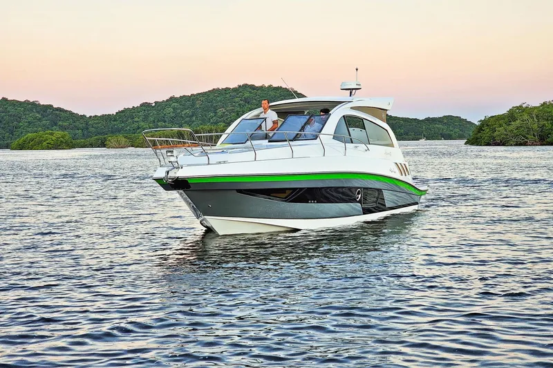 Slide: The Image of Luxury Hanover 375 yacht cruising on serene waters at sunset, 2026 model. - 2