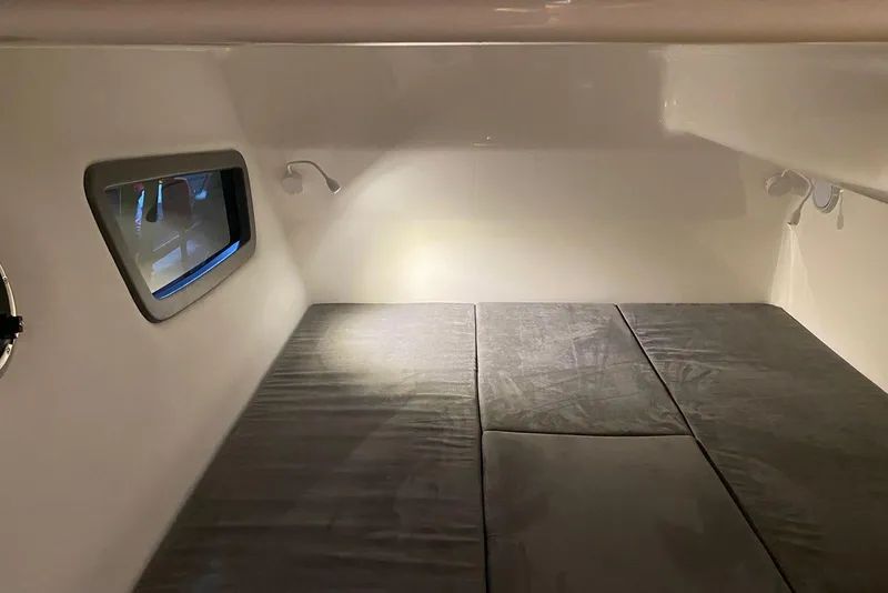 Slide: The Image of Interior cabin of 2026 Hanover 375 with cushioned bed and window view. - 16