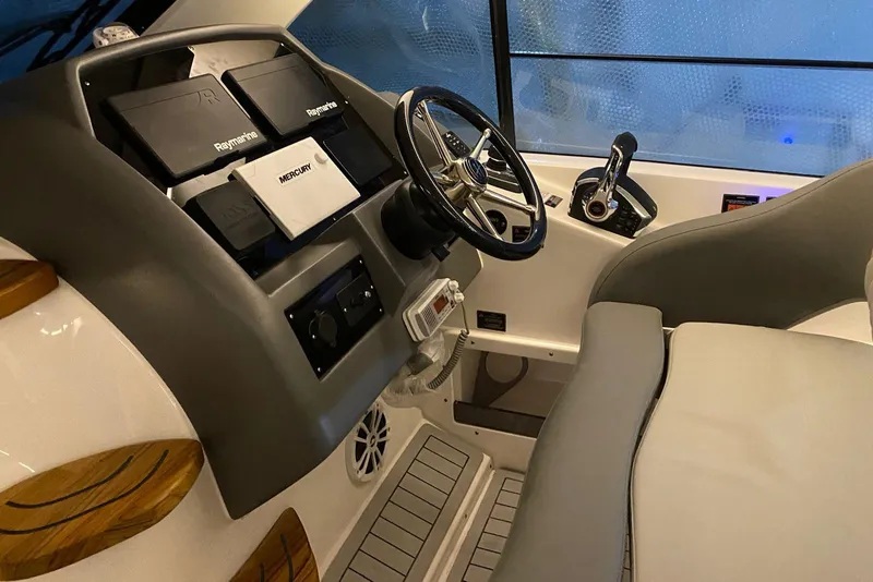 Slide: The Image of Interior of 2026 Hanover 375 boat cockpit with steering wheel and navigation equipment. - 8