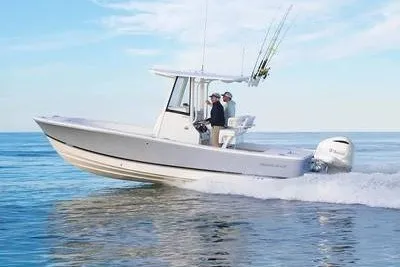 The Image of 2027 Regulator 24XO boat cruising on open water with two passengers. - 1