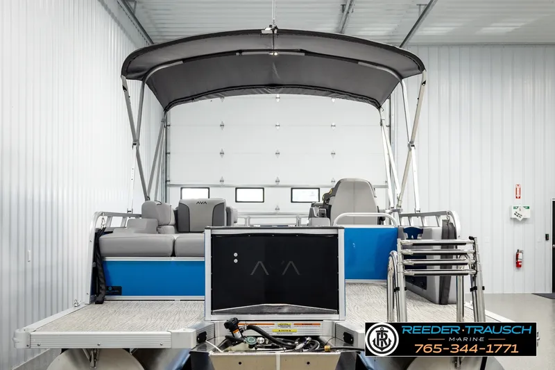 Slide: The Image of 2026 Avalon VEN85 RF pontoon boat in a showroom with canopy and seating. - 7