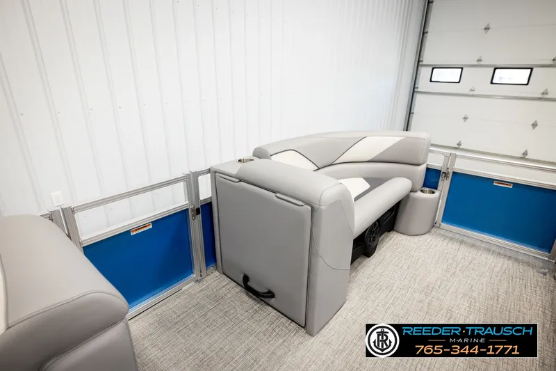Slide: The Image of 2026 Avalon VEN85 RF boat interior with gray seating and blue accents in a showroom. - 20