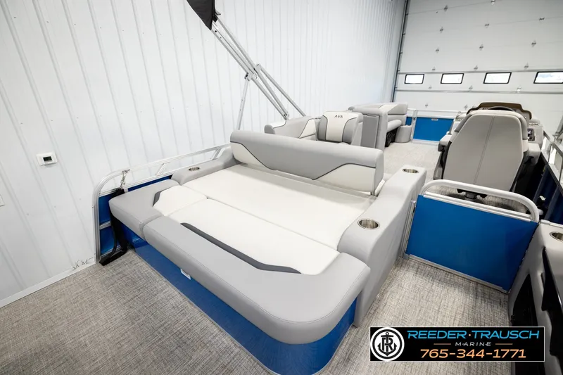 Slide: The Image of 2026 Avalon VEN85 RF boat interior with gray seating and blue accents in a showroom. - 28