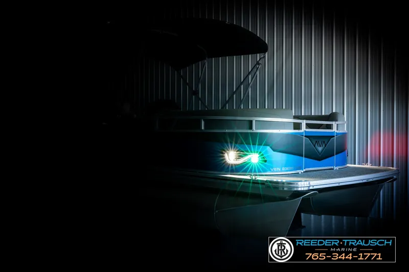 Slide: The Image of 2026 Avalon VEN85 RF pontoon boat with illuminated lights in a dimly lit setting. - 4