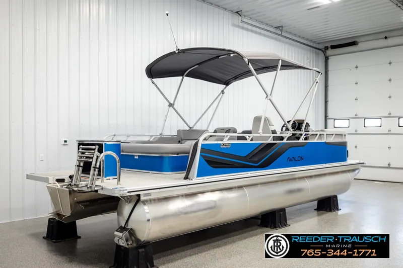 Slide: The Image of 2026 Avalon VEN85 RF pontoon boat in showroom, featuring blue and gray design. - 6