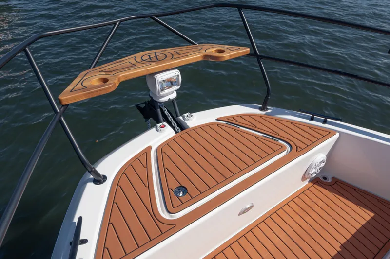 Slide: The Image of Bow of 2026 Hanover 387 boat with teak decking and railing on water. - 26