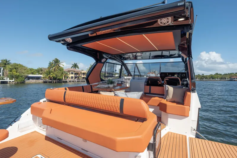 Slide: The Image of Luxurious 2026 Hanover 387 yacht interior with orange seating, cruising on a scenic waterway. - 13
