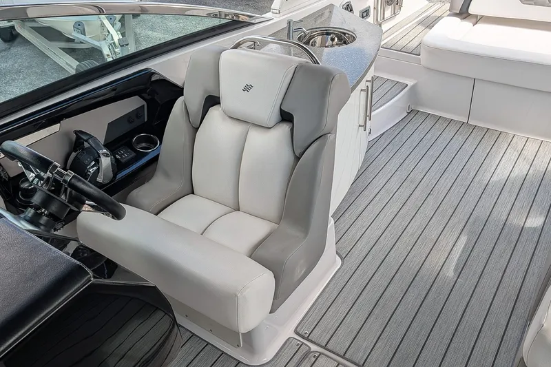 Slide: The Image of 2019 Four Winns H290 OB boat interior with helm seat and sleek design. - 15