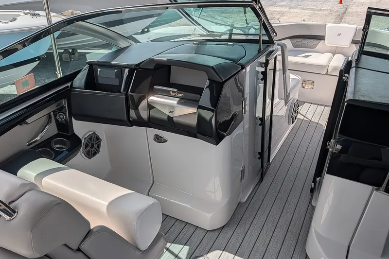 Slide: The Image of 2019 Four Winns H290 OB boat interior with sleek seating and modern dashboard design. - 23