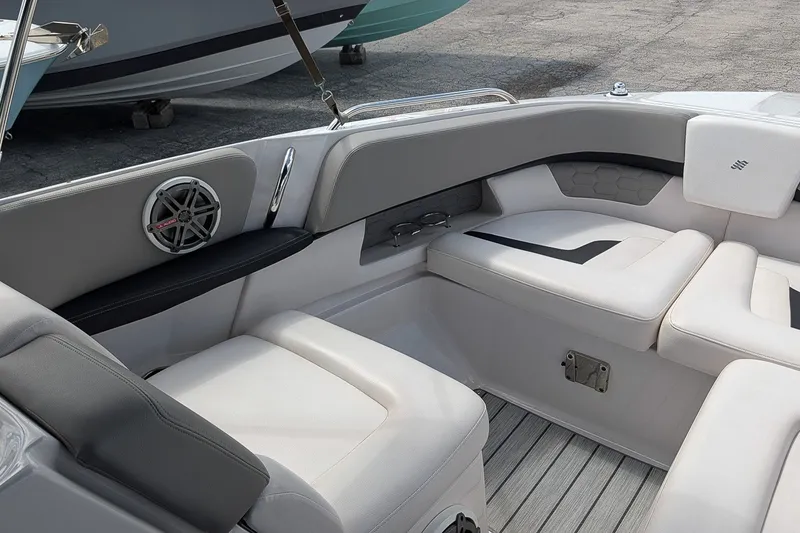Slide: The Image of 2019 Four Winns H290 OB boat interior with white seating and speaker detail. - 31