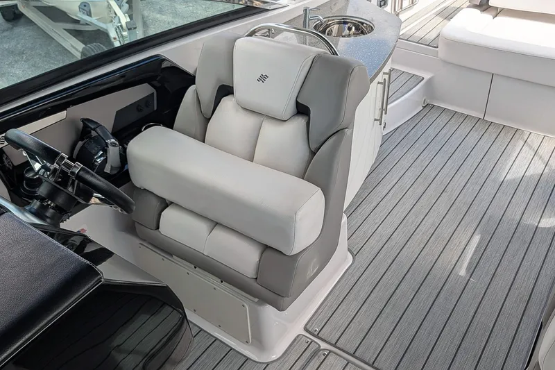 Slide: The Image of 2019 Four Winns H290 OB boat interior with helm seat and steering wheel. - 14