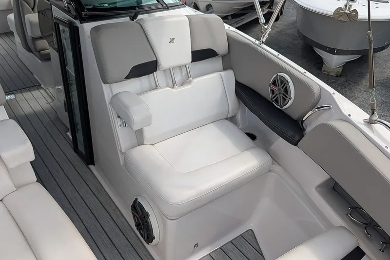 Slide: The Image of 2019 Four Winns H290 OB boat interior with cushioned seating and speaker system. - 29