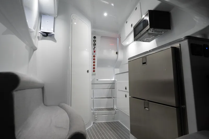 Slide: The Image of 2024 Contender 44 Fisharound cabin interior with modern appliances and sleek design. - 18