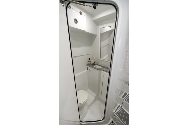 Slide: The Image of 2024 Contender 44 Fisharound boat bathroom interior with toilet and sink. - 66