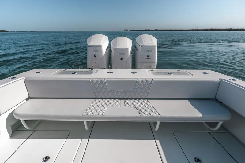 Slide: The Image of 2024 Contender 44 Fisharound boat with triple outboard engines on open water. - 21