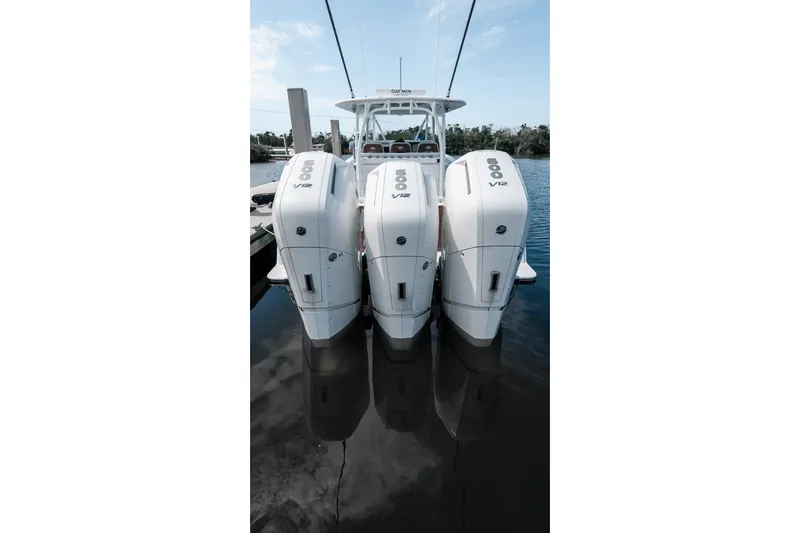 Slide: The Image of 2024 Contender 44 Fisharound with triple 600 V12 outboard engines on calm water. - 70