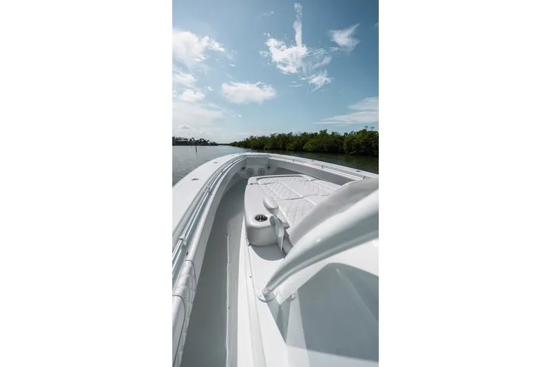 Slide: The Image of 2024 Contender 44 Fisharound boat cruising on a sunny day, showcasing sleek design. - 62