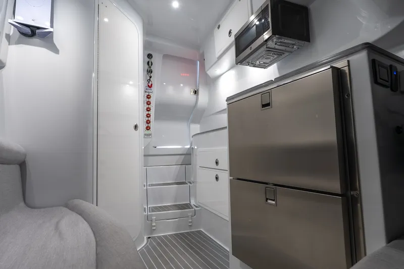 Slide: The Image of 2024 Contender 44 Fisharound cabin interior with modern appliances and sleek design. - 13