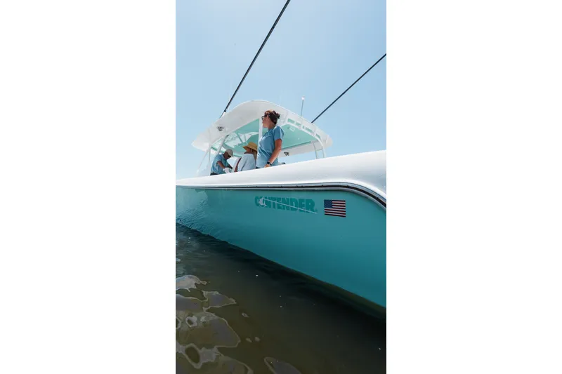 Slide: The Image of 2024 Contender 44 Fisharound boat on water, featuring sleek design and American flag decal. - 60