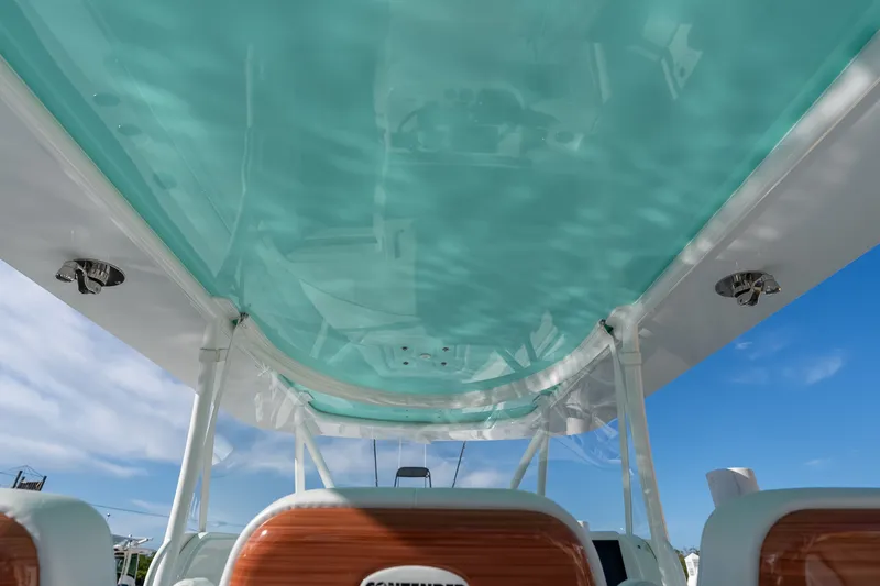 Slide: The Image of 2024 Contender 44 Fisharound boat interior with turquoise ceiling and clear sky. - 7
