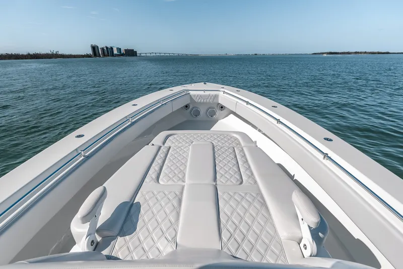 Slide: The Image of 2024 Contender 44 Fisharound boat on calm water, featuring luxurious seating and sleek design. - 43