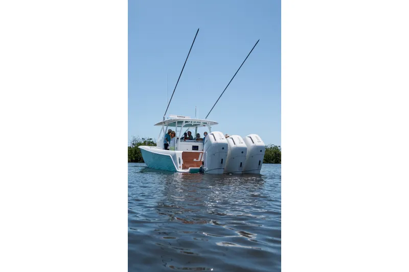 Slide: The Image of 2024 Contender 44 Fisharound boat with triple engines on calm water. - 58