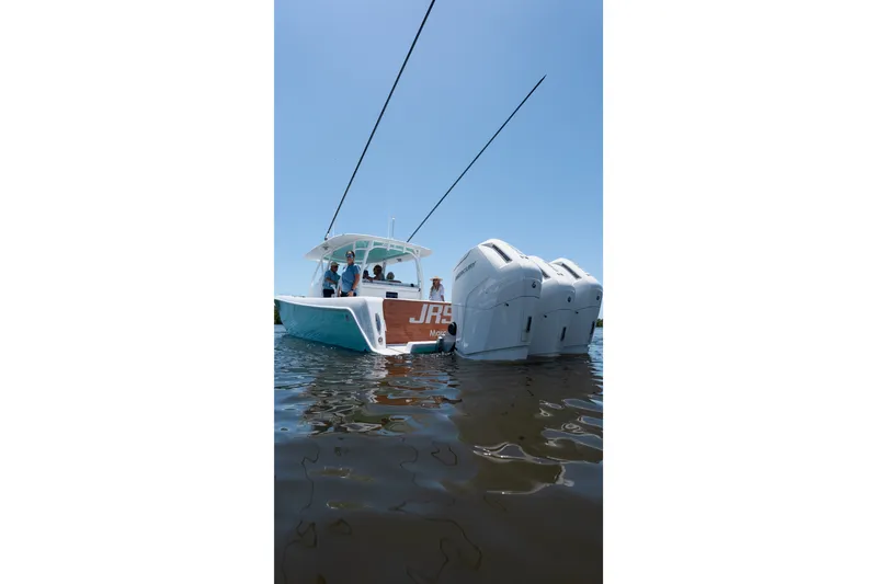 Slide: The Image of 2024 Contender 44 Fisharound boat with triple engines on calm water. - 59