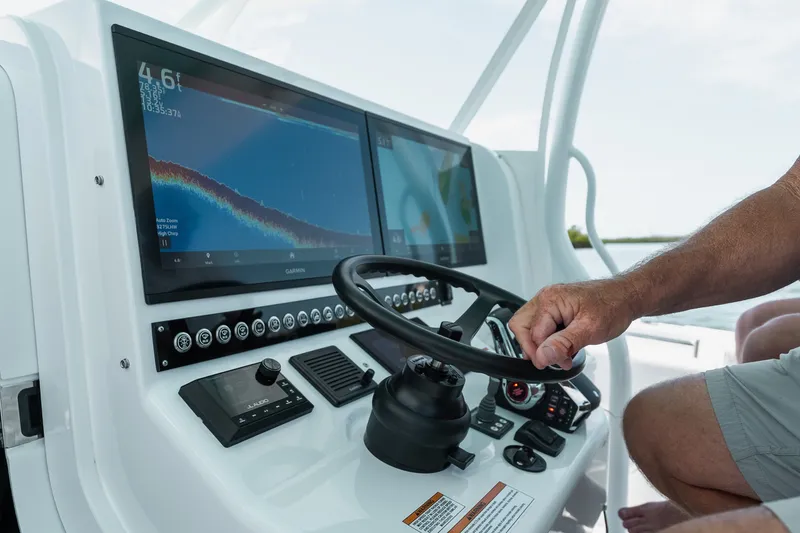 Slide: The Image of 2024 Contender 44 Fisharound helm with advanced navigation displays and steering wheel. - 52