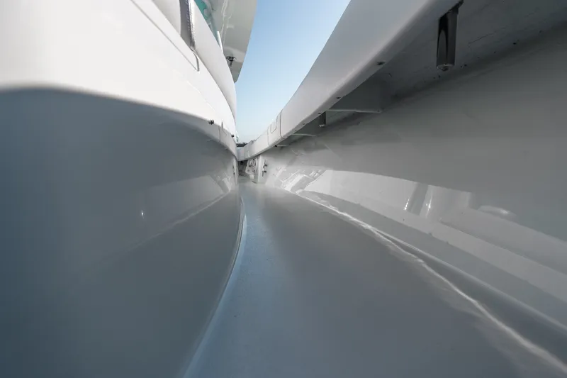 Slide: The Image of 2024 Contender 44 Fisharound boat, sleek side view with smooth, reflective surfaces. - 27