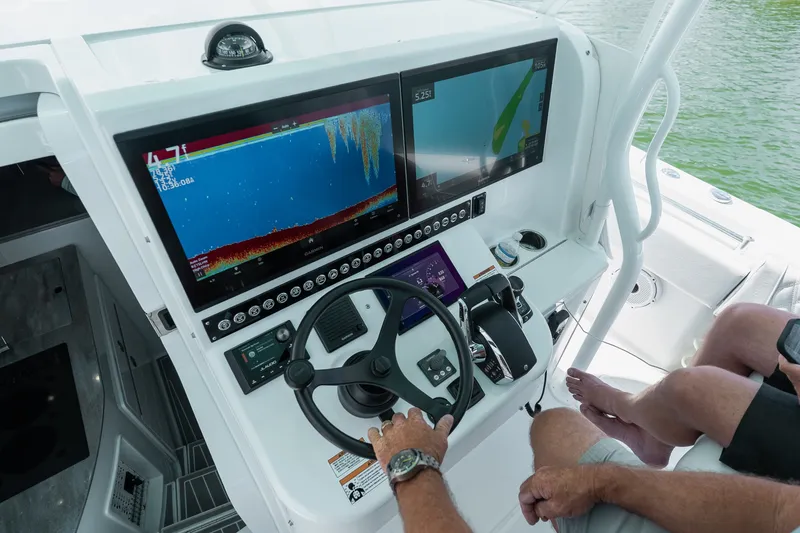 Slide: The Image of 2024 Contender 44 Fisharound helm with advanced navigation displays and controls. - 53