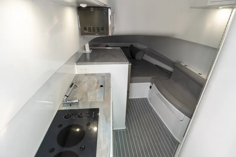 Slide: The Image of 2024 Contender 44 Fisharound interior with modern kitchenette and cozy seating area. - 9
