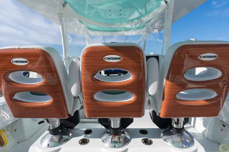 Slide: The Image of 2024 Contender 44 Fisharound boat seats with wooden accents and Contender logo. - 5