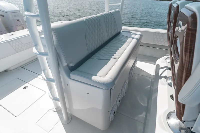 Slide: The Image of 2024 Contender 44 Fisharound boat interior with cushioned seating and ocean view. - 38
