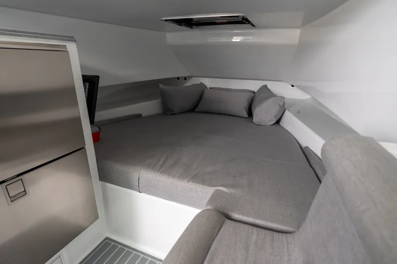 Slide: The Image of 2024 Contender 44 Fisharound cabin interior with cozy bed and modern design. - 11