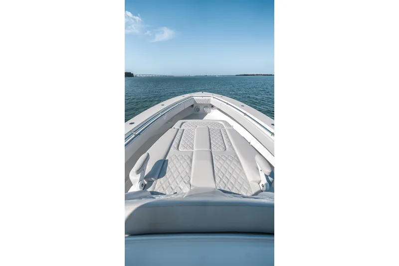 Slide: The Image of 2024 Contender 44 Fisharound boat with cushioned deck, cruising on open water. - 44