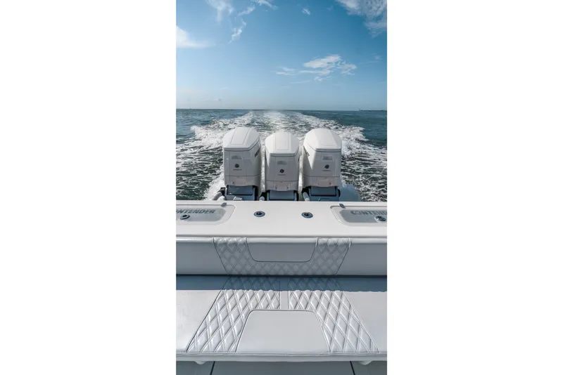 Slide: The Image of 2024 Contender 44 Fisharound boat with triple engines cruising on open water. - 45