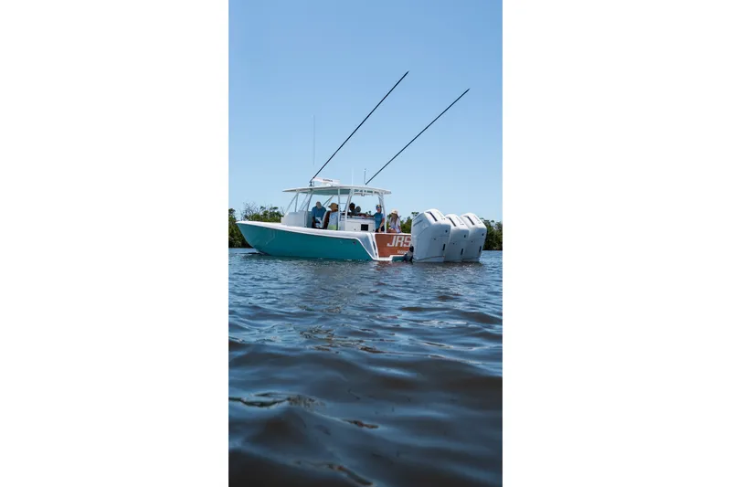 Slide: The Image of 2024 Contender 44 Fisharound boat on water, equipped with multiple outboard engines. - 1