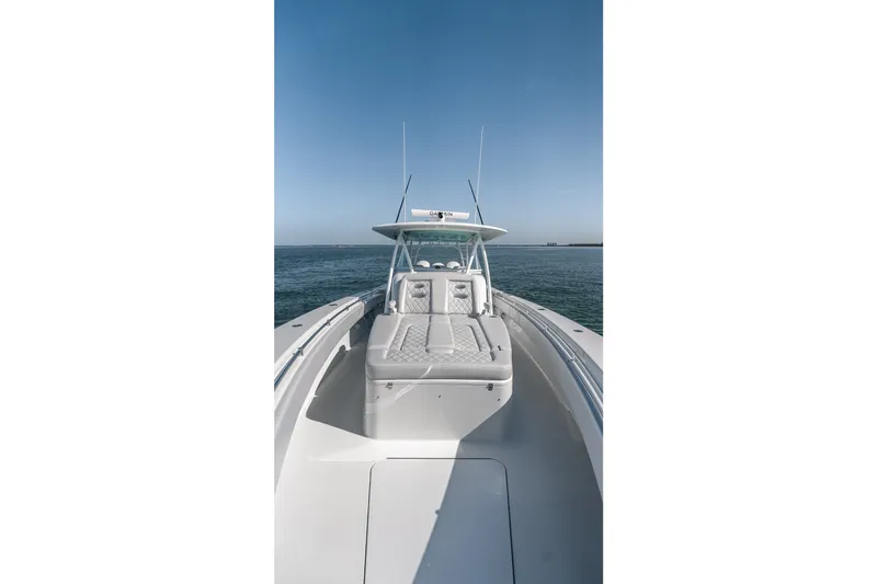 Slide: The Image of 2024 Contender 44 Fisharound boat on open water, showcasing sleek design and spacious deck. - 42