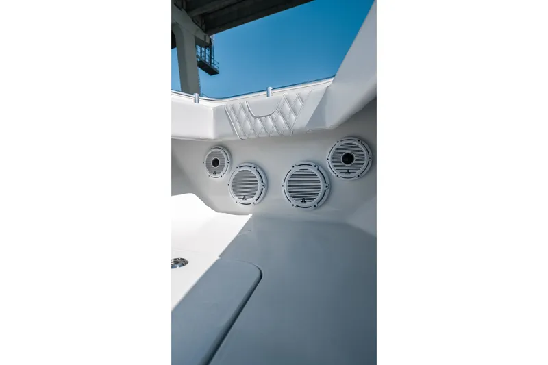 Slide: The Image of 2024 Contender 44 Fisharound boat interior with speakers and quilted upholstery detail. - 48