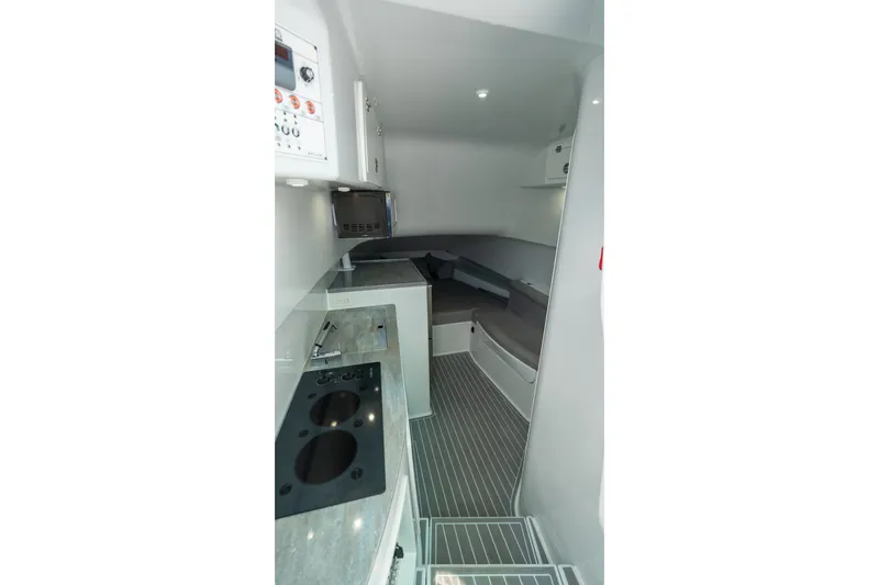 Slide: The Image of 2024 Contender 44 Fisharound cabin interior with modern kitchen and seating area. - 64
