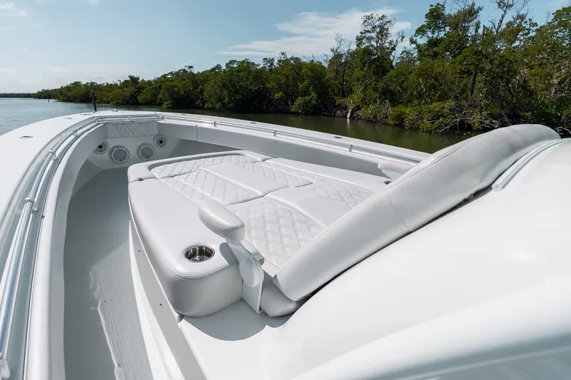 Slide: The Image of 2024 Contender 44 Fisharound boat with luxurious seating, cruising on a serene waterway. - 63